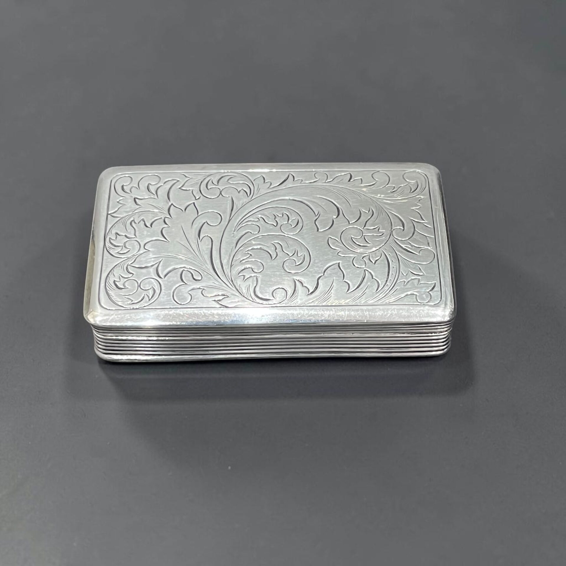 Ornate foliate scroll engraved gilt silver snuff box